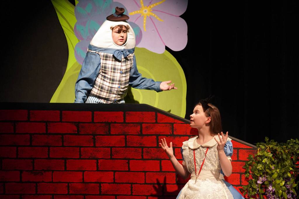 Riley Hinton is Humpty Dumpty and Aurora Bukac is Alice in a rehearsal of Seward High School Theatre Collectives production of Alice in Wonderland at Seward High School in Seward, Alaska, on Thursday, April 11, 2024. (Jake Dye/Peninsula Clarion)
