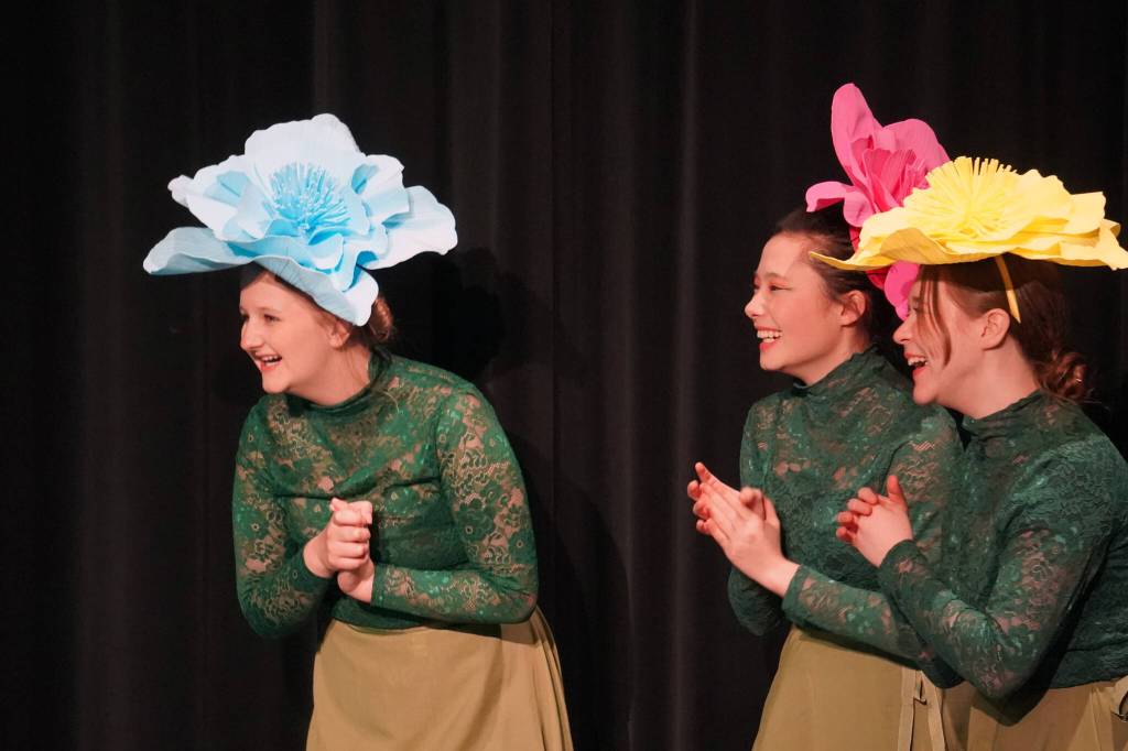 Amara Ranson, Nia Mulholland-Kim and Ava Gunter are Flowers in a rehearsal of Seward High School Theatre Collectives production of Alice in Wonderland at Seward High School in Seward, Alaska, on Thursday, April 11, 2024. (Jake Dye/Peninsula Clarion)