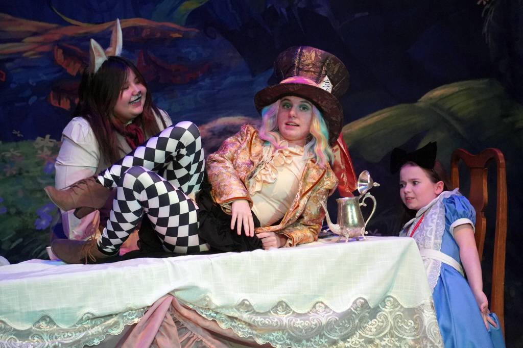 Lily Biocic is March Hare, Lily Mooter is Hatter and Aurora Bukac is Alice in a rehearsal of Seward High School Theatre Collectives production of Alice in Wonderland at Seward High School in Seward, Alaska, on Thursday, April 11, 2024. (Jake Dye/Peninsula Clarion)