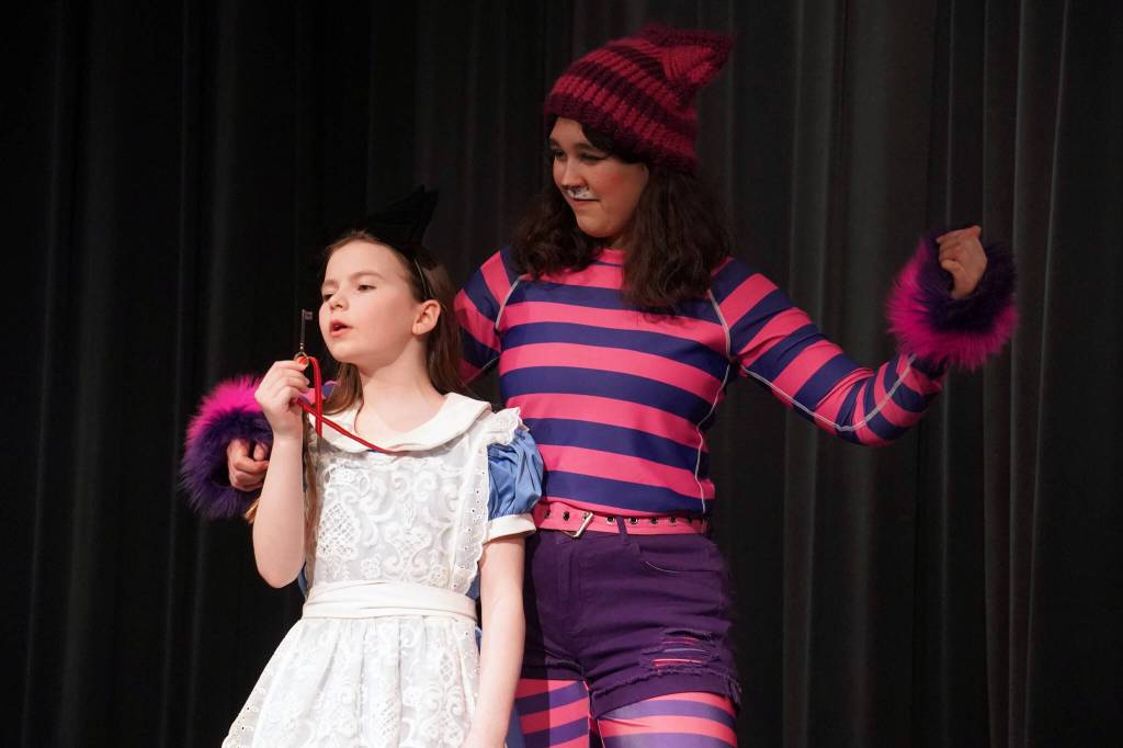 Aurora Bukac is Alice and Lily Miles-Dafoe is the Cheshire Cat in a rehearsal of Seward High School Theatre Collectives production of Alice in Wonderland at Seward High School in Seward, Alaska, on Thursday, April 11, 2024. (Jake Dye/Peninsula Clarion)