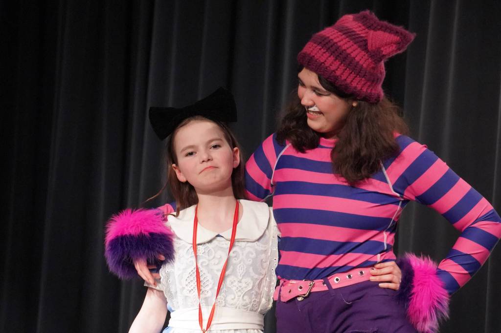 Aurora Bukac is Alice and Lily Miles-Dafoe is the Cheshire Cat in a rehearsal of Seward High School Theatre Collectives production of Alice in Wonderland at Seward High School in Seward, Alaska, on Thursday, April 11, 2024. (Jake Dye/Peninsula Clarion)