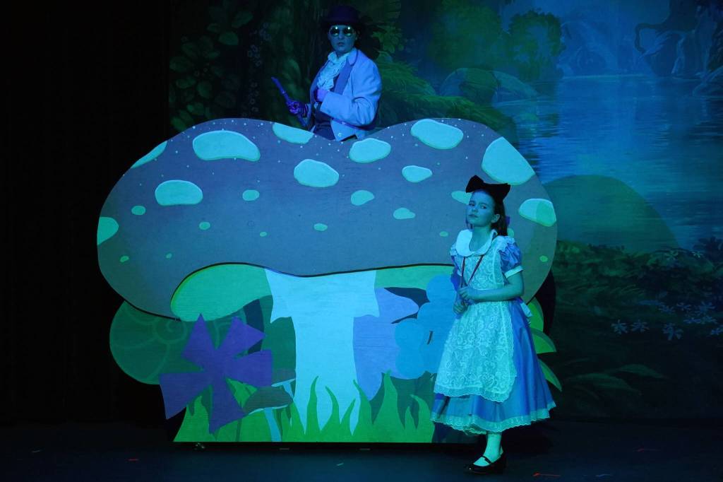Evelyn Bukac is Blue Caterpillar and Aurora Bukac is Alice in a rehearsal of Seward High School Theatre Collectives production of Alice in Wonderland at Seward High School in Seward, Alaska, on Thursday, April 11, 2024. (Jake Dye/Peninsula Clarion)