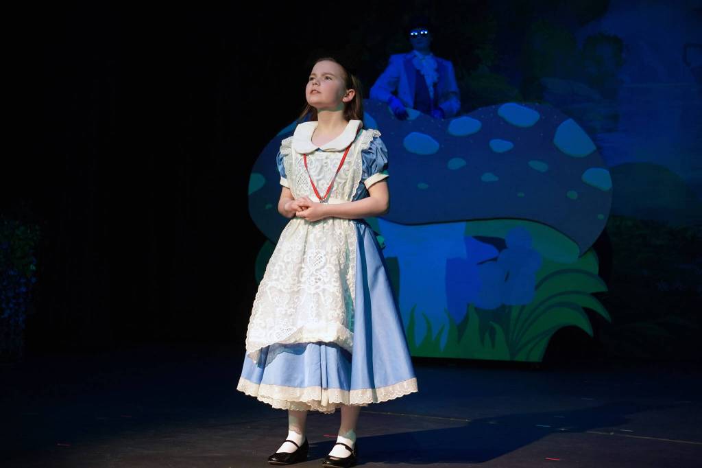 Aurora Bukac is Alice and Evelyn Bukac is Blue Caterpillar in a rehearsal of Seward High School Theatre Collective's production of "Alice in Wonderland" at Seward High School in Seward, Alaska, on Thursday, April 11, 2024. (Jake Dye/Peninsula Clarion)