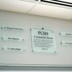 A plaque dedicates the Community Room to five people who played significant roles in the organizations history at Peninsula Community Health Services in Soldotna, Alaska, is seen on Monday, April 15, 2024. (Jake Dye/Peninsula Clarion)