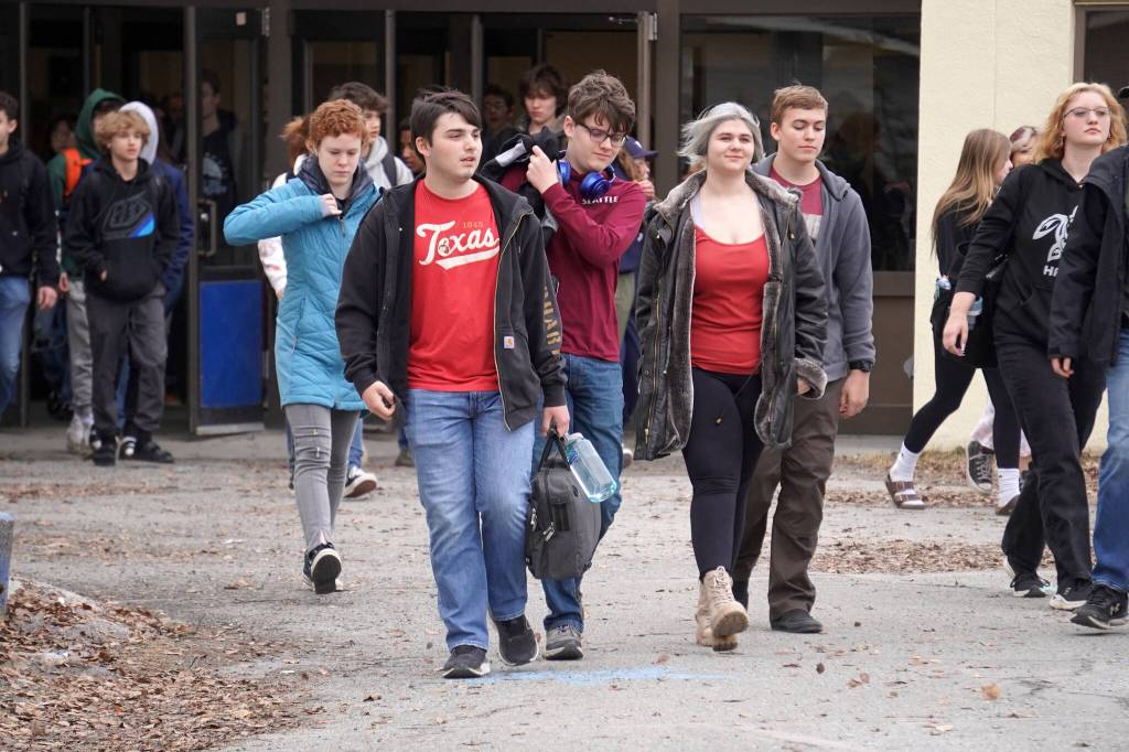 Students of Soldotna High School walk out of class for a protest of the veto of Senate Bill 140 in front of their school in Soldotna, Alaska, on Wednesday, April 17, 2024. (Jake Dye/Peninsula Clarion)