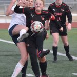 Homers Ruby Hill and Kenai Centrals Kylee Verkuilen battle for the ball Tuesday, April 16, 2024, at Ed Hollier Field at Kenai Central High School in Kenai, Alaska. (Photo by Jeff Helminiak/Peninsula Clarion)