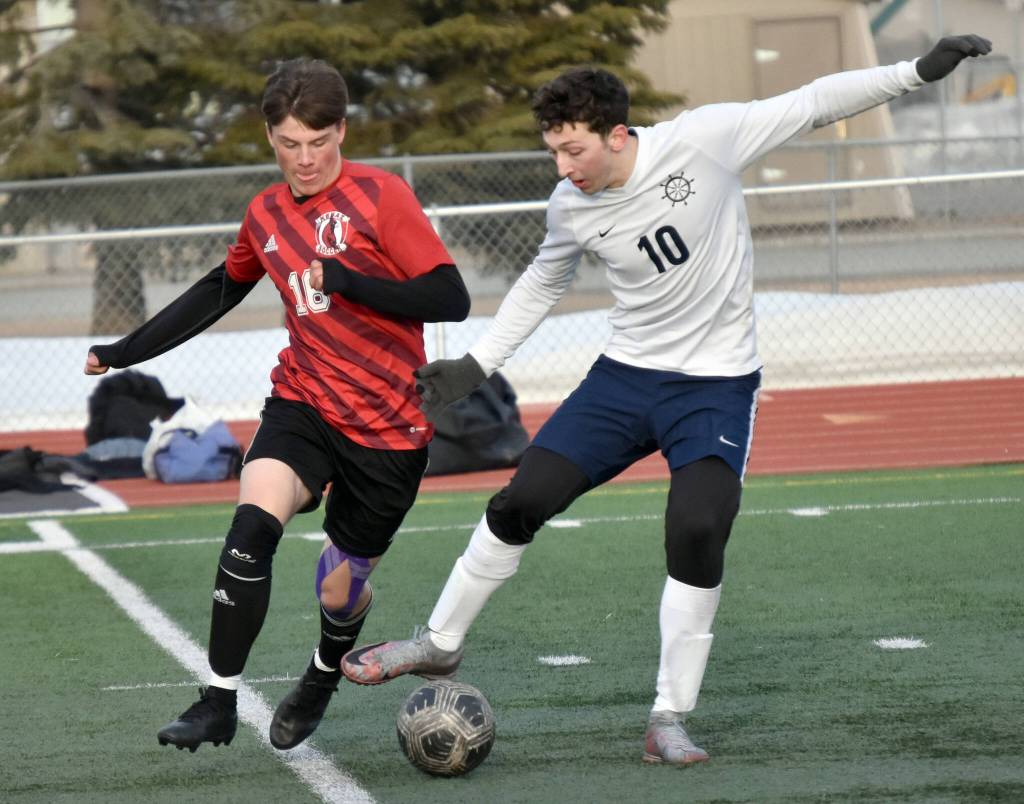 Kenai Centrals Sawyer Vann and Homers Lucas Story battle for the ball Tuesday, April 16, 2024, at Ed Hollier Field at Kenai Central High School in Kenai, Alaska. (Photo by Jeff Helminiak/Peninsula Clarion)