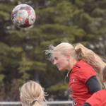Kenai Central's Kate Wisnewski heads the ball wide of the net Friday, April 19, 2024, at Kenai Central High School in Kenai, Alaska. (Photo by Jeff Helminiak/Peninsula Clarion)