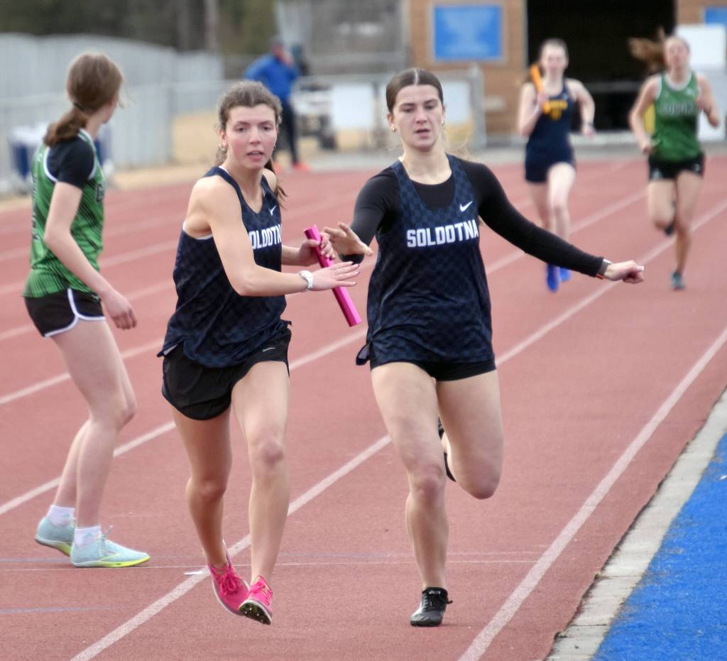 Soldotnas Anaulie Sedivy hands off to Annie Burns in the 1,600-meter relay Saturday, April 20, 2024, at the Soldotna Invitational at Soldotna High School in Soldotna, Alaska. (Photo by Jeff Helminiak/Peninsula Clarion)