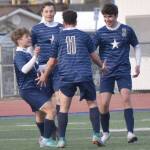Soldotnas Andrew Arthur (right) celebrates his goal with teammates Owen Buckbee, Zac Buckbee and Nuno Venturi on Tuesday, April 23, 2024, at Soldotna High School in Soldotna, Alaska. (Photo by Jeff Helminiak/Peninsula Clarion)
