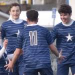 Soldotna's Andrew Arthur (right) celebrates his goal with teammates Owen Buckbee, Zac Buckbee and Nuno Venturi on Tuesday, April 23, 2024, at Soldotna High School in Soldotna, Alaska. (Photo by Jeff Helminiak/Peninsula Clarion)