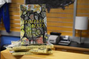 John Messicks Compass Lines is displayed at the Kenai Peninsula College Bookstore in Soldotna, Alaska on Tuesday, March 28, 2023. The copy at the top of this stack is the same that reporter Jake Dye purchased and read for this review. (Jake Dye/Peninsula Clarion)