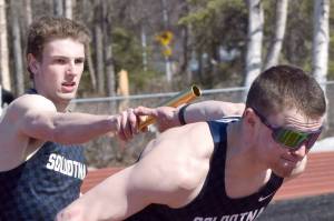 Soldotna's James Innes hands to Jeren Nash on Soldotna's winning 400-meter relay Saturday, April 27, 2024, at the Kenai Invitational at Kenai Central High School in Kenai, Alaska. (Photo by Jeff Helminiak/Peninsula Clarion)
