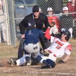 Kenai Centrals Zane Pellegrom slides under the tag of Soldotnas Ari Miller on Monday, April 29, 2024, at the Kenai Little League fields in Kenai, Alaska. (Photo by Jeff Helminiak/Peninsula Clarion)