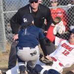 Kenai Central's Zane Pellegrom slides under the tag of Soldotna's Ari Miller on Monday, April 29, 2024, at the Kenai Little League fields in Kenai, Alaska. (Photo by Jeff Helminiak/Peninsula Clarion)