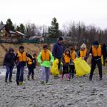 Students of Soldotna Montessori Charter School comb for trash along the banks of the Kenai River at Centennial Park in Soldotna, Alaska, on Thursday, May 2, 2024. (Jake Dye/Peninsula Clarion)