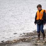 Students of Soldotna Montessori Charter School comb for trash along the banks of the Kenai River at Centennial Park in Soldotna, Alaska, on Thursday, May 2, 2024. (Jake Dye/Peninsula Clarion)