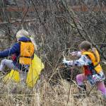 Students of Soldotna Montessori Charter School comb for trash along the banks of the Kenai River at Centennial Park in Soldotna, Alaska, on Thursday, May 2, 2024. (Jake Dye/Peninsula Clarion)