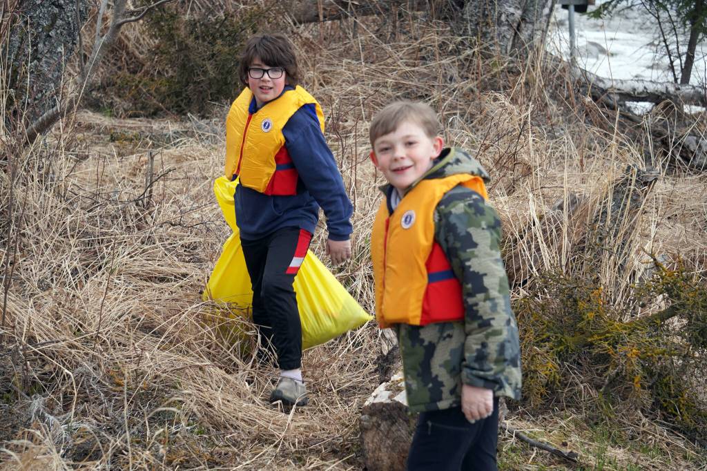 Students of Soldotna Montessori Charter School comb for trash along the banks of the Kenai River at Centennial Park in Soldotna, Alaska, on Thursday, May 2, 2024. (Jake Dye/Peninsula Clarion)