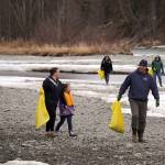 Students of Soldotna Montessori Charter School comb for trash along the banks of the Kenai River at Centennial Park in Soldotna, Alaska, on Thursday, May 2, 2024. (Jake Dye/Peninsula Clarion)