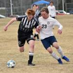 Nikiskis Johnny Ralston dribbles against Homers Espen Hennick on Saturday, May 4, 2024, at Nikiski Middle-High School in Nikiski, Alaska. (Photo by Jeff Helminiak/Peninsula Clarion)