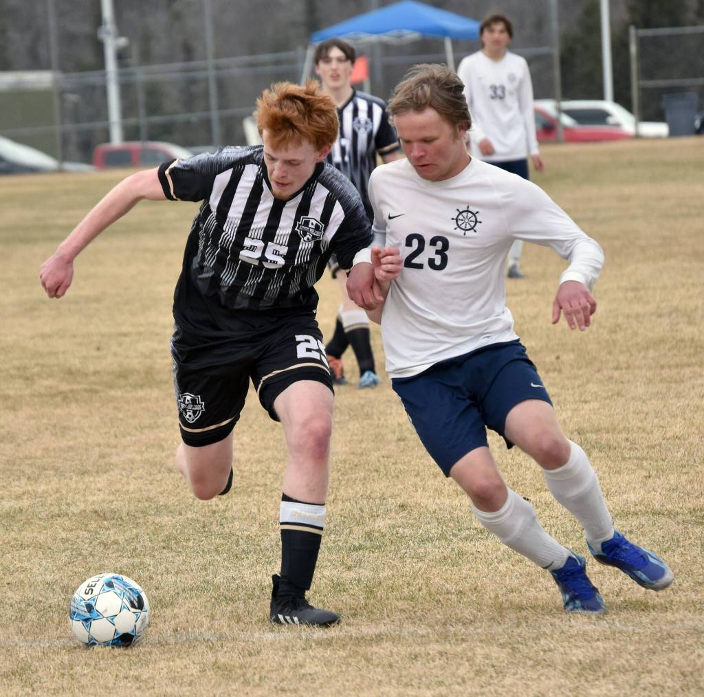 Nikiskis Johnny Ralston dribbles against Homers Espen Hennick on Saturday, May 4, 2024, at Nikiski Middle-High School in Nikiski, Alaska. (Photo by Jeff Helminiak/Peninsula Clarion)
