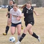 Homers Talia Weisser dribbles against Nikiskis Zoey Ellis on Saturday, May 4, 2024, at Nikiski Middle-High School in Nikiski, Alaska. (Photo by Jeff Helminiak/Peninsula Clarion)