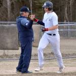 Soldotna head coach Ken Gibson congratulates Wyatt Gagnon after his two-run home run Tuesday, May 7, 2024, at the Soldotna Little League fields in Soldotna, Alaska. (Photo by Jeff Helminiak/Peninsula Clarion)