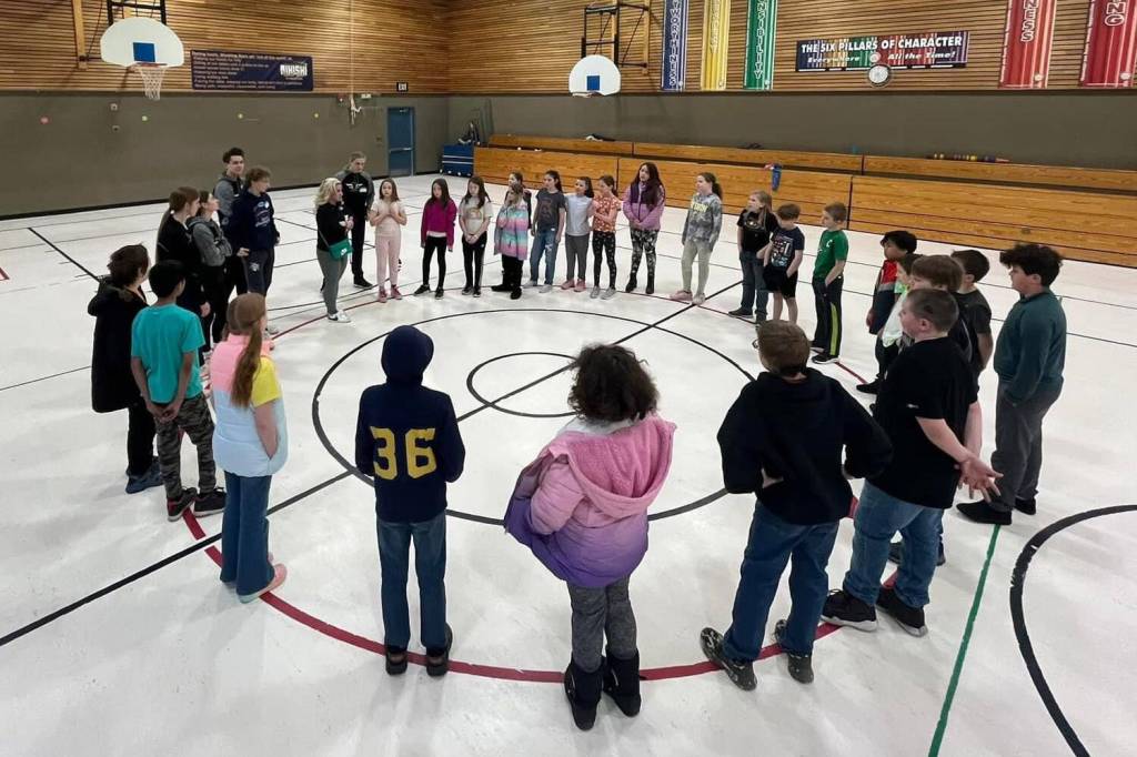 Athletes from Nikiski Middle/High Schools track and field team visit with elementary students at Nikiski North Star Elementary School in Nikiski, Alaska. (Photo provided)