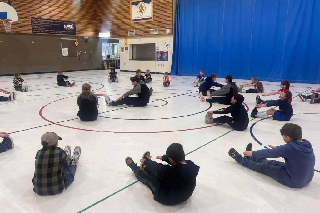Athletes from Nikiski Middle/High Schools track and field team lead an exercise with elementary students at Nikiski North Star Elementary School in Nikiski, Alaska. (Photo provided)