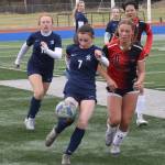 Soldotnas Bay Bloom kicks the ball in front of Houstons Bella Russell on Friday, May 10, 2024, at Soldotna High School in Soldotna, Alaska. (Photo by Jeff Helminiak/Peninsula Clarion)