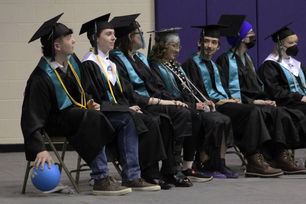 River City Academy Salutatorian Christopher Smith (left) bounces a ball thrown to him by Principal Shea Nash during the schools commencement ceremony on Monday, May 13, 2024 near Soldotna, Alaska. (Ashlyn OHara/Peninsula Clarion)