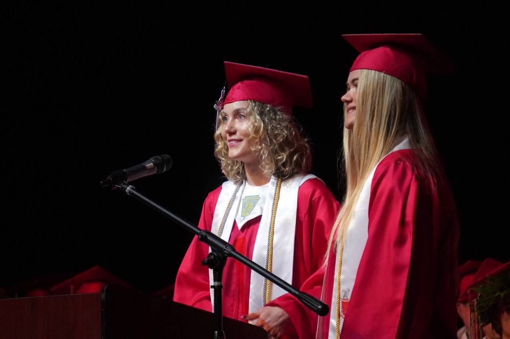 Senior class speakers Ashlyn Potton and Emma Beck deliver a joke while speaking to fellow students of Kenai Central High School at their graduation ceremony in the schools auditorium in Kenai, Alaska, on Monday, May 13, 2024. (Jake Dye/Peninsula Clarion)