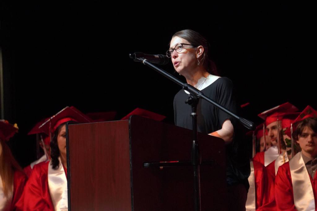Commencement Speaker Kristin Davis offers words of advice to students of Kenai Central High School at their graduation ceremony in the schools auditorium in Kenai, Alaska, on Monday, May 13, 2024. (Jake Dye/Peninsula Clarion)