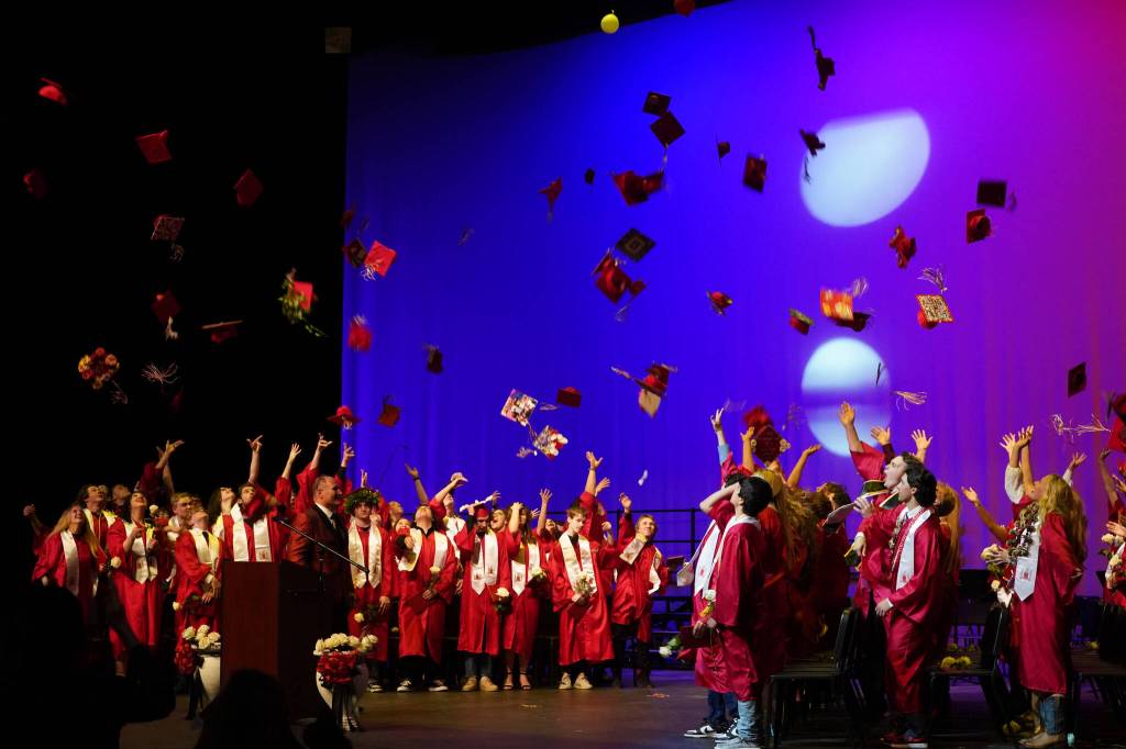 Students of Kenai Central High School celebrate at the end of their graduation ceremony in the schools auditorium in Kenai, Alaska, on Monday, May 13, 2024. (Jake Dye/Peninsula Clarion)