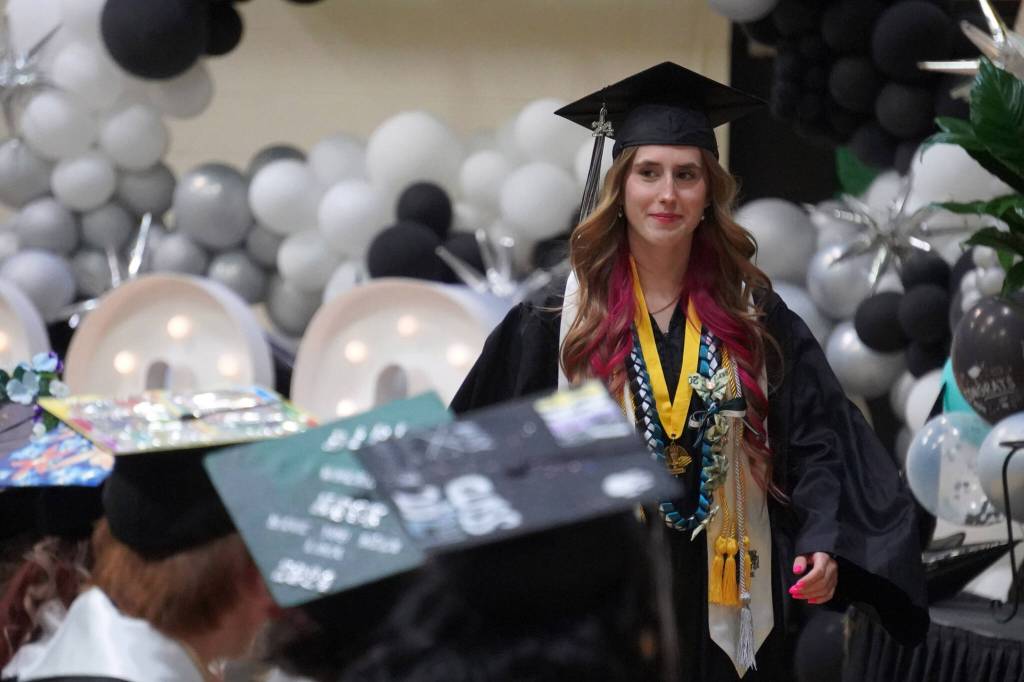 Valedictorian Shelby McGahan rises to speak during a graduation ceremony at Nikiski Middle/High School in Nikiski, Alaska, on Wednesday, May 15, 2024. (Jake Dye/Peninsula Clarion)