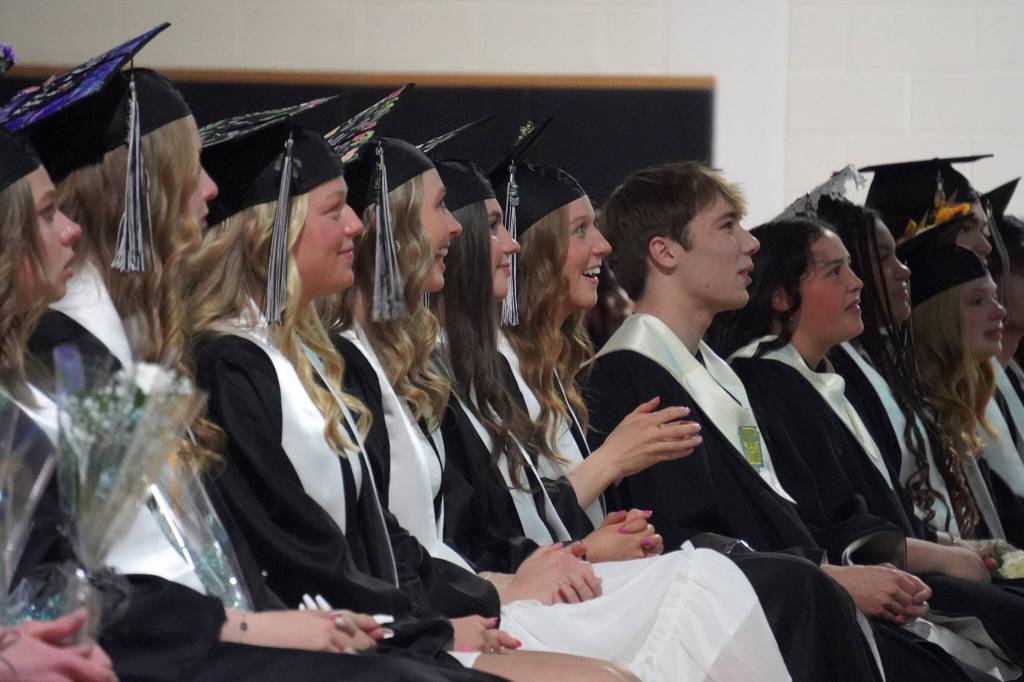 Nikiski Middle/High School graduates smile, cry and clap along to their slide show during a graduation ceremony in the schools gym in Nikiski, Alaska, on Wednesday, May 15, 2024. (Jake Dye/Peninsula Clarion)