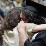 Nikiski Middle/High School graduates hold tightly to their supporters during a graduation ceremony in the schools gym in Nikiski, Alaska, on Wednesday, May 15, 2024. (Jake Dye/Peninsula Clarion)