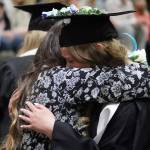Nikiski Middle/High School graduates hold tightly to their supporters during a graduation ceremony in the schools gym in Nikiski, Alaska, on Wednesday, May 15, 2024. (Jake Dye/Peninsula Clarion)