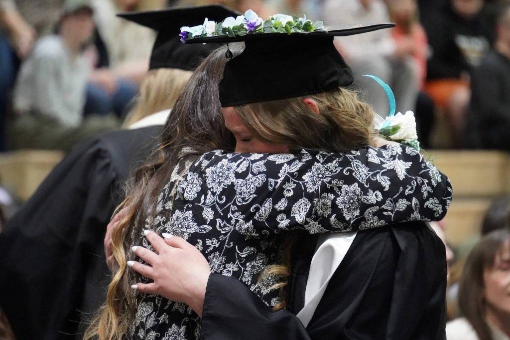 Nikiski Middle/High School graduates hold tightly to their supporters during a graduation ceremony in the schools gym in Nikiski, Alaska, on Wednesday, May 15, 2024. (Jake Dye/Peninsula Clarion)