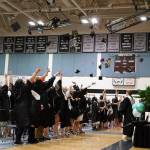 Nikiski Middle/High School graduates throw their caps into the air at the conclusion of a graduation ceremony in the schools gym in Nikiski, Alaska, on Wednesday, May 15, 2024. (Jake Dye/Peninsula Clarion)