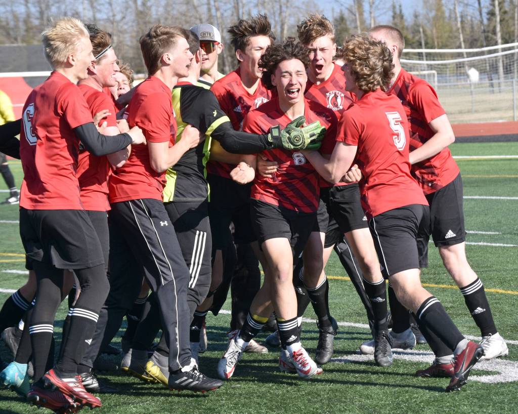 Kenai Centrals Kainoa Taylor (8) celebrates his game-winning goal in the penalty kick shootout against Homer on Friday, May 17, 2024, at Kenai Central High School in Kenai, Alaska. (Photo by Jeff Helminiak/Peninsula Clarion)