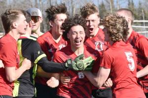 Kenai Central's Kainoa Taylor (8) celebrates his game-winning goal in the penalty kick shootout against Homer on Friday, May 17, 2024, at Kenai Central High School in Kenai, Alaska. (Photo by Jeff Helminiak/Peninsula Clarion)