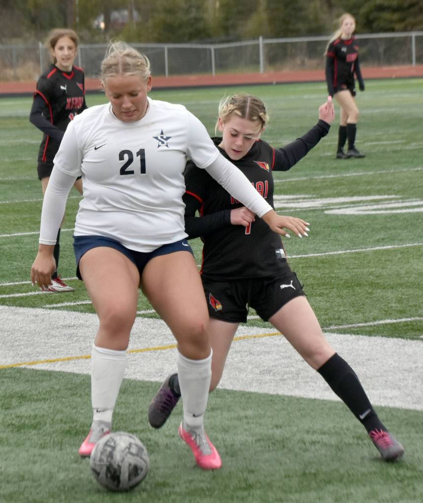 Soldotnas Morgan Lemm shields the ball from Kenai Centrals Tait Cooper on Saturday, May 18, 2024, at the Peninsula Conference tournament at Kenai Central High School in Kenai, Alaska. (Photo by Jeff Helminiak/Peninsula Clarion)