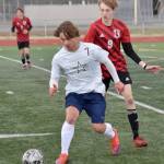 Soldotnas Johnny Wardas shields the ball from Kenai Centrals Zane James on Saturday, May 19, 2024, at the Peninsula Conference tournament at Kenai Central High School in Kenai, Alaska. (Photo by Jeff Helminiak/Peninsula Clarion)
