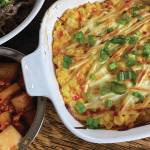 Corn cheese is served alongside grilled beef, kimchi and lettuce. (Photo by Tressa Dale/Peninsula Clarion)