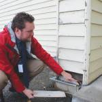 Soldotna Elementary School Principal Dr. Austin Stevenson points out corroded insulation outside of the school building on Friday, Sept. 30, 2022 in Soldotna, Alaska. (Ashlyn OHara/Peninsula Clarion)