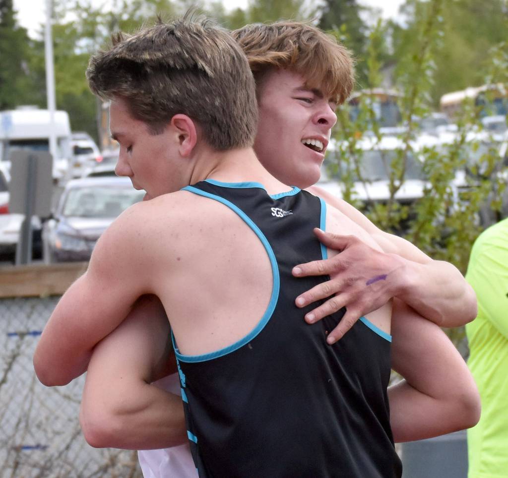 Nikiskis Ryder Maguire congratulates Kenai Centrals Greg Fallon on his win in the 800 meters at the Division II state track and field meet Saturday, May 25, 2024, at Dimond High School in Anchorage, Alaska. Maguire was sixth. (Photo by Jeff Helminiak/Peninsula Clarion)