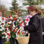 Poppies are affixed to wreaths during a Memorial Day ceremony at Leif Hanson Memorial Park in Kenai, Alaska, on Monday, May 27, 2024. (Jake Dye/Peninsula Clarion)