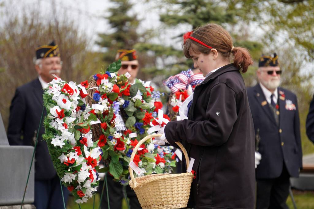 Poppies are affixed to wreaths during a Memorial Day ceremony at Leif Hanson Memorial Park in Kenai, Alaska, on Monday, May 27, 2024. (Jake Dye/Peninsula Clarion)